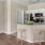 a kitchen with stools at open counter