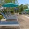 a pool with lounge chairs and umbrellas by it