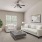 carpeted living room with window and ceiling fan