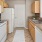 galley kitchen with tiled floors